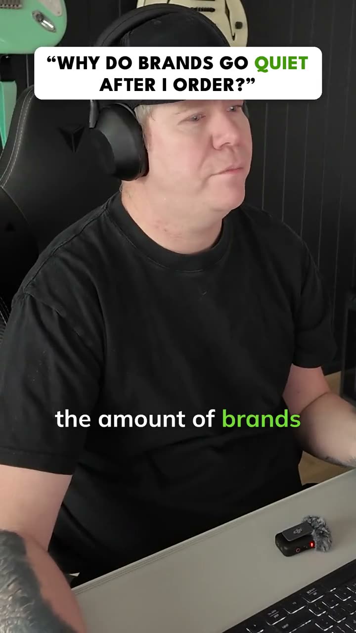 Paul Warren mid-sentence at the studio desk, headphones on, under the question card: Why do brands go quiet after I order?